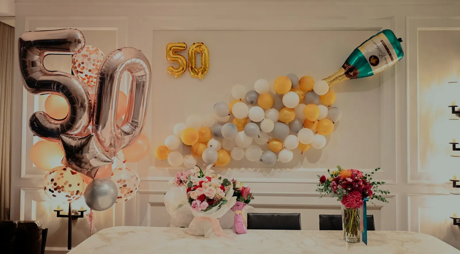 A 50th birthday party set up with balloons and flowers